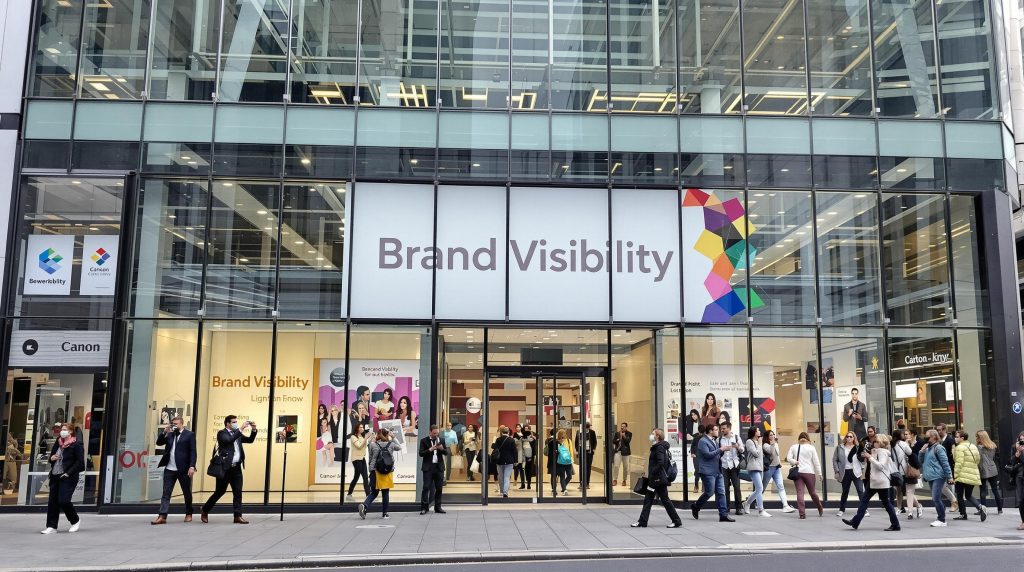 London office exterior with large branded banners and window graphics
