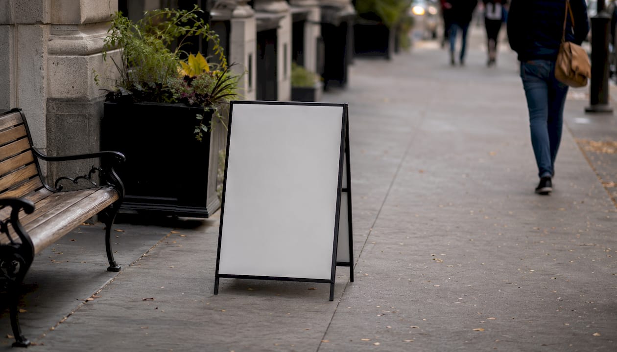 Properly placed pavement sign on narrow sidewalk
