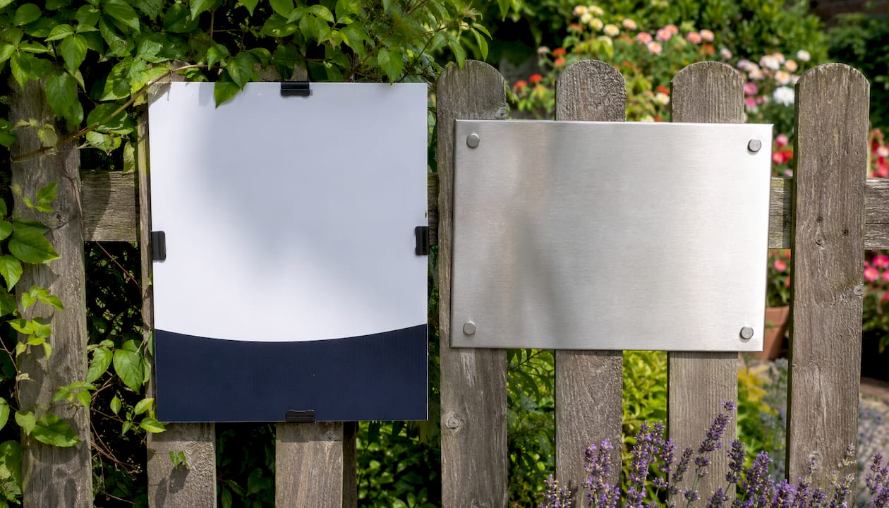 Close-up contrast of removable vs permanent UK signs