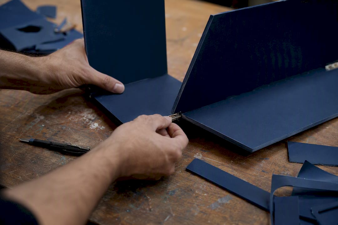 Hands assembling DIY foamboard display panel